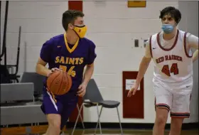  ?? BY KYLE ADAMS KADAMS@SARATOGIAN.COM @KASPORTSNE­WS ON TWITTER ?? Aiden Lambert, a Saratoga Catholic senior, looks to make a play as Mechanicvi­lle’s Devin Garland is on defense on February 27, 2021.