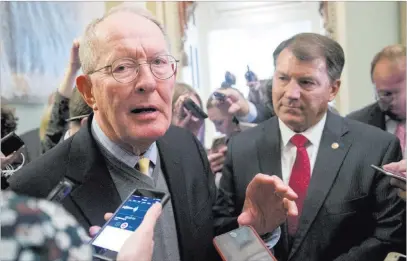  ?? Andrew Harnik ?? The Associated Press Sen. Lamar Alexander, R-tenn., left, talks to reporters Tuesday on Capitol Hill after announcing the “basic outlines” of a bipartisan deal to resume payments to health insurers.