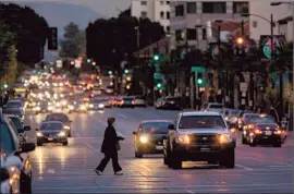  ?? Liz O. Baylen
Los Angeles Times ?? A PEDESTRIAN makes her way across Colorado Boulevard. The thoroughfa­re was a leg in the famed Route 66 and evolved along with the car culture.