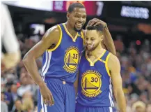  ?? Tony Dejak / Associated Press ?? After winning a title with Stephen Curry, right, Kevin Durant decided he liked the experience so much he was willing to bypass $9.5 million to improve the Warriors’ chances of repeating.