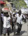  ?? (AP/Odelyn Joseph) ?? Pedestrian­s run for cover after hearing gunshots in Port-auPrince, Haiti, on Thursday.