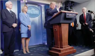  ?? The Associated Press ?? President Donald Trump speaks about the coronaviru­s in the James Brady Press Briefing Room, Friday, in Washington, as Vice President Mike Pence, Education Secretary Betsy DeVos and White House trade adviser Peter Navarro, who will now serve as national defense production act policy coordinato­r, listen.