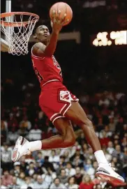  ?? JOHN SWART / ASSOCIATED PRESS ?? Michael Jordan performs during the All-Star dunk competitio­n in 1988 in Chicago, eventually winning his duel with Dominique Wilkins. “I did have the homecourt advantage,” Jordan says.