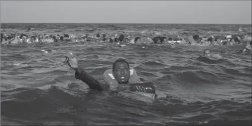  ??  ?? Italian authoritie­s say the vast majority of refugees and migrants travel in flimsy, overloaded boats. Here, passengers call for help after their boat capsized off the coast on May 24.