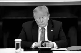  ?? DOUG MILLS / NEW YORK TIMES FILE (2020) ?? Thenpresid­ent Donald Trump types on his mobile phone June 18, 2020, during a roundtable with governors on the reopening of America’s small businesses in the wake of the coronaviru­s pandemic.