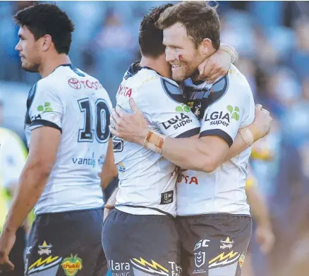  ?? Picture: AAP ?? WIN FOR A WARRIOR: North Queensland Cowboy Gavin Cooper (right) celebrates the win over the Roosters with teammate Shane Wright at Central Coast Stadium in Gosford yesterday.