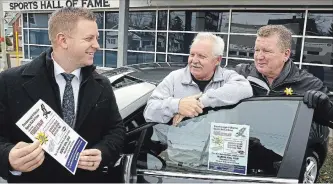  ?? CLIFFORD SKARSTEDT EXAMINER ?? Sports Hall of Fame vehicle draw chairman Steve Casey, middle, chats with Jack McGee Chev Cadillac GMC Buick sales manager Jon Jackson, left, and sales consultant Doug Evans, on Tuesday at the Memorial Centre.