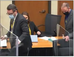  ?? (AP/Court TV) ?? Defense attorney Eric Nelson (left) and former Minneapoli­s police officer Derek Chauvin take their seats Wednesday as Judge Peter Cahill presides over jury selection in Chauvin’s trial in Minneapoli­s.