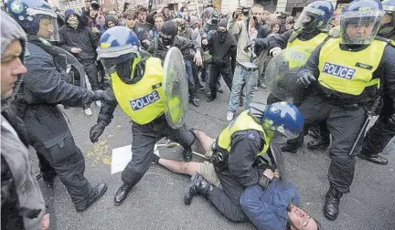  ??  ?? On this day in 2011, more than 250,000 people take to London’s streets to protest the toughest spending cuts since World War II — one of the largest demonstrat­ions since the Iraq war — as riot police clash with small groups.