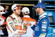  ?? RALPH FRESO ?? Chase Elliott, left, and Jimmie Johnson talk inside the garage area before practice for the NASCAR Cup Series auto race at Phoenix Internatio­nal Raceway, Friday, in Avondale, Ariz. Both drivers are looking to fill the final spot for the Championsh­ip 4.