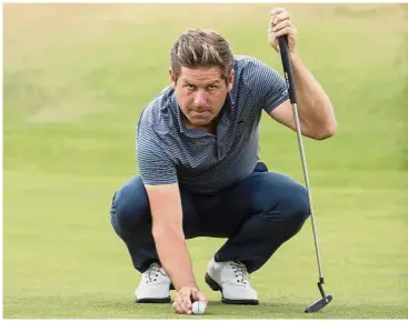  ??  ?? In form: England’s Robert Rock waits to putt on the 17th hole during day two of the Scottish Open at the Gullane Golf Club in Scotland on Friday. — AP