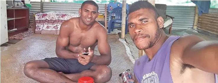  ??  ?? Epeli Momo (left) with his uncle Akuila Tuivuna during breakfast at Korobebe Village in Nadi on May 17, 2020.