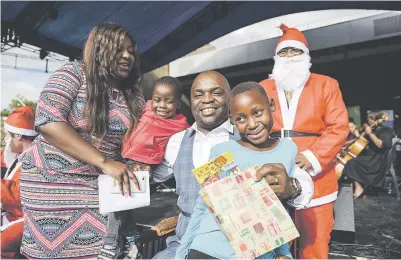  ?? Picture: Jacques Nelles ?? Tshwane mayor Solly Msimanga gives a present to an orphan at Freedom Park yesterday during a Christmas Candleligh­t event. The city sponsored gifts and lunch for 800 children.