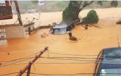  ??  ?? A handout picture released on Monday by Society 4 Climate Change Communicat­ion Sierra Leone shows flooded streets in Regent near Freetown.
