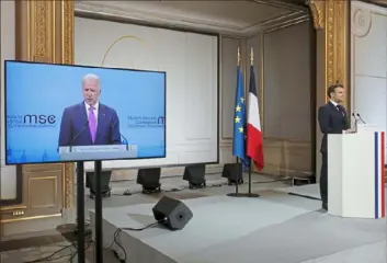  ?? Benoit Tessier/Pool via AP ?? French President Emmanuel Macron, right, in Paris, attends a videoconfe­rence as President Joe Biden appears on a screen ahead of the Munich Security Conference on Friday.