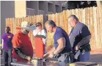  ?? COURTESY OF COOKING CHANNEL ?? Shannon Ambrosio, second from right, competes during his show “Big Bad BBQ Brawl.” The episode was filmed at Pepper’s Ole Fashion BBQ in Albuquerqu­e.