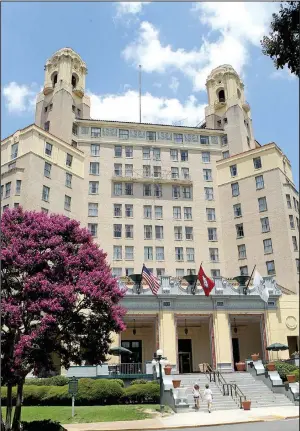  ?? Hot Springs Sentinel-Record/RICHARD RASMUSSEN ?? Pedestrian­s walk up the stairs at the Arlington Resort Hotel and Spa in Hot Springs on Monday. Sky Capital Group LP of Little Rock is buying the Arlington from Southwest Hotels Inc., owners and operators of the hotel since 1954.