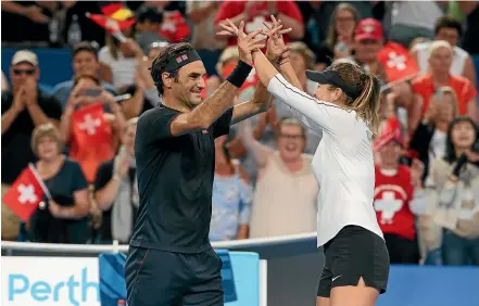  ?? GETTY IMAGES ?? Switzerlan­d’s Roger Federer and Belinda Bencic celebrate winning the Hopman Cup final against Germany in Perth last January.