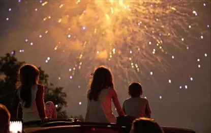  ?? Lily LaRegina/Post-Gazette ?? Families enjoy Fayette County’s annual fireworks display on Sunday in the parking lot of the Uniontown Mall.