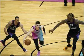  ?? LYNNE SLADKY — THE ASSOCIATED PRESS ?? 76ers guard George Hill, left, and center Dwight Howard, right, put the squeeze on Miami Heat guard Tyler Herro Thursday night. Hill’s defensive skills would be a boost to the starting lineup.