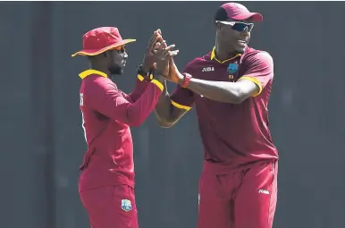  ?? FILE ?? Kesrick Williams (left) and Carlos Brathwaite celebrate.