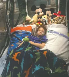  ?? ALEX JAKEMAN ?? Noah Jakeman, in the ICU at Phoenix Children’s Hospital, is surrounded by gifts sent by Bill Clayten and his friends.