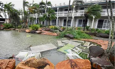  ??  ?? Destructiv­e
gusts: Outdoor furniture lying in a pool at a motel as Cyclone Debbie hits the northern Queensland town of Airlie Beach, located south of Townsville in Australia. — Reuters