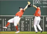  ?? Elise Amendola / Associated Press ?? Red Sox second baseman Brock Holt, left, leans back to catch a pop fly by the Rays’ Avisail Garcia in the eighth inning of Boston’s 5-1 loss on Friday in Boston.