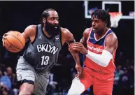  ?? Frank Franklin II / Associated Press ?? The Brooklyn Nets’ James Harden (13) drives past the Washington Wizards’ Aaron Holiday during their game on Monday in New York.