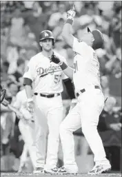  ?? Chris Carlson Associated Press ?? JOC PEDERSON CELEBRATES after hitting his 11th home run of the season, a two-run shot in the second inning that brought in Alex Wood (57).