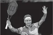  ?? Aaron Favila / The Associated Press ?? Roger Federer celebrates after defeating Jurgen Melzer in their first-round match at the Australian Open.