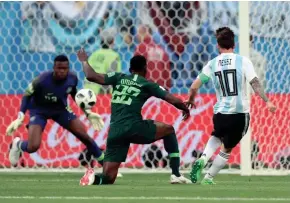  ??  ?? Lionel Messi scores Argentina’s first goal during a Group D World Cup match Tuesday against Nigeria in Saint Petersburg, Russia.