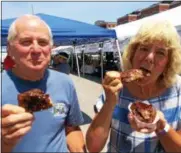  ?? PAUL POST — PPOST@DIGITALFIR­STMEDIA.COM ?? Terry and Betty Fortna of Ballston Spa enjoyed barbecue ribs from 2 West Bar &amp; Grille at the Eat Drink Saratoga festival on Saturday.