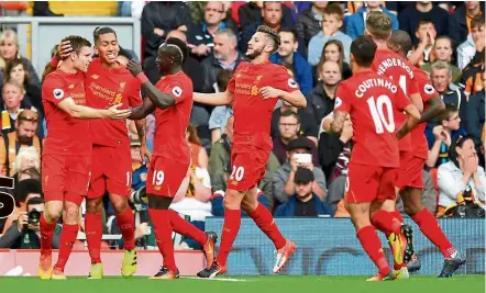  ?? — AP ?? Rampant Reds: Liverpool’s James Milner (left) celebrates scoring his side’s second goal during their English Premier League match against Hull at Anfield yesterday. Milner scored twice from the spot in the Reds’ 5-1 win.