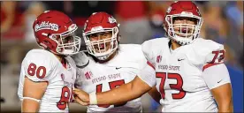  ?? HARRY HOW / GETTY IMAGES ?? Micah St. Andrew #73 celebrates with Gunner Javernick #80 and Syrus Tuitele #65 of the Fresno State Bulldogs during their 38-14 win over the UCLA Bruins on Sept. 15, 2018. St. Andrew began to reshape his body after high school, going from a walk-on to full scholarshi­p to an undrafted free agent with the Detroit Lions.