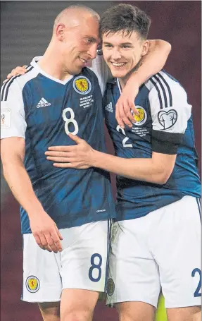  ??  ?? O CAPTAIN MY CAPTAIN: Scott Brown embraces Kieran Tierney after his storming display at right-back for Scotland on Sunday night.