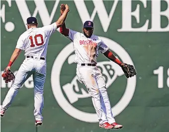  ?? ELISE AMENDOLA/ASSOCIATED PRESS ?? Boston outfielder­s Hunter Renfroe (10) and Franchy Cordero exchange a leaping high five after the Red Sox’s 11-4 victory over the Chicago White Sox on Monday at Fenway Park.