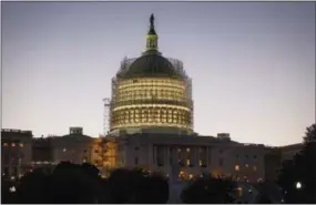  ?? THE ASSOCIATED PRESS ?? The Capitol Dome is nearly obscured by scaffoldin­g at dawn in Washington as restoratio­n efforts continue.