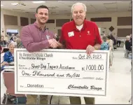  ?? (Courtesy Photo) ?? On Oct. 20, St. Bernard’s Charitable Bingo presented a check in the amount of $1,000 to Tim Hocut (left) of Sheep Dog Impact Assistance. Presenting the check is Paul Meyer representi­ng St. Bernard Catholic Church in Bella Vista. Bingo is played at 6:30 p.m. on the third Thursday of the month in the parish hall. A snack bar is available during bingo as well. All are welcome.