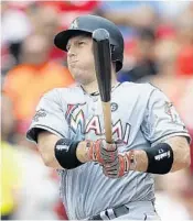  ?? GARY LANDERS/AP ?? Marlins catcher A.J. Ellis follows through on a fourth-inning solo home run off Reds pitcher Sal Romano.