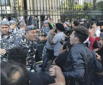  ??  ?? Demonstrat­ors clash with police in front of the Beirut Bar Associatio­n building yesterday EPA