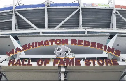  ?? SUSAN WALSH — THE ASSOCIATED PRESS ?? Signs for the Washington Redskins are displayed outside FedEx Field in Landover, Md., Monday. The Washington NFL franchise announced Monday that it will drop the “Redskins” name and Indian head logo immediatel­y.