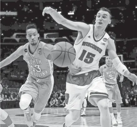  ?? FILE PHOTO ?? Wisconsin's Sam Dekker is held by North Carolina's JP Tokoto as he goes for a loose ball. Both were Class of 2012 recruits out of Wisconsin high schools.