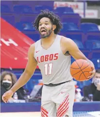  ?? UNM ATHLETICS ?? UNM guard Jeremiah Francis shown recently in Lubbock, Texas, as the Lobos played Utah State in their home away from home. No fans, a pandemic-mandated lockdown and the latest blowout lose, 82-46 to the Aggies, has taken its toll on the team.