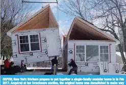  ??  ?? DEPEW, New York: Workers prepare to put together a single-family modular home in in Feb 2017. Acquired at tax foreclosur­e auction, the original home was demolished to make way for new constructi­on by the county land bank. —Reuters