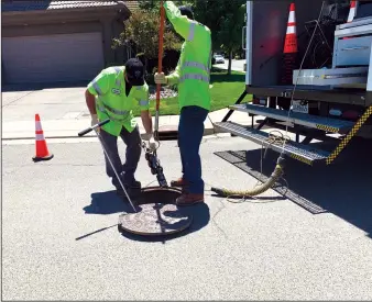  ?? COURTESY PHOTOGRAPH/RITA HILL ?? Employees with the Lodi Public Works Department lower a camera into a storm drain in an attempt to rescue baby ducklings in the Bridgetown­e subdivisio­n on Wednesday in Lodi.