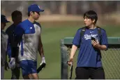  ?? CAROLYN KASTER - THE ASSOCIATED PRESS, FILE ?? Ippei Mizuhara (right), the former longtime interprete­r for Dodgers slugger Shohei Ohtani, was charged with federal bank fraud for crimes involving gambling debts and theft.
MLB standings