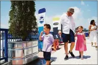  ?? ?? Jonathan Kimble walks with his family at the Steelpoint­e Yacht and Charter Show on Friday.