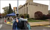  ?? GENE J. PUSKAR — THE ASSOCIATED PRESS FILE ?? People pay their respects at a makeshift memorial outside the Tree of Life Synagogue in the Squirrel Hill neighborho­od of Pittsburgh.