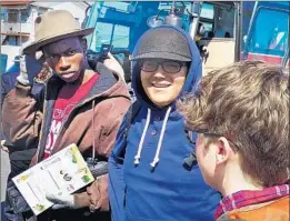  ?? Mark Swed Los Angeles Times ?? YOLA MEMBERS Daniel Egwurube, left, and Edson Natareno, center, arrive in Soma, Japan, to perform with young Japanese musicians.